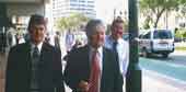 Photo shows three parliamentarians walking on  Wellington's main street. 
