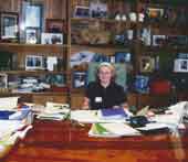 Photo shows young girl seated at the Prime Ministers desk. 