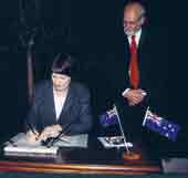 Photo of the Prime Minister signing the Kyoto Protocol. 