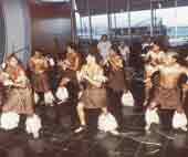 Photo shows pacific island group of dancers. 