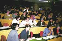 Photo shows people in a lecture room. 