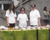 Photo of three women at an information table. 
