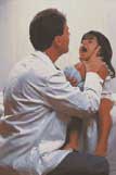 A photo of a small child opening her mouth for the doctor to examine her throat. 
