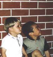 Photo shows two boys of different ethnic origins. 