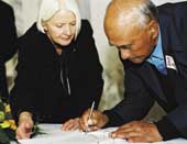 Photo shows Hon Margaret Wilson and Tai Te Runi  signing the document. 