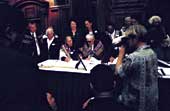 Photo shows people signing the Deed of Settlement. 