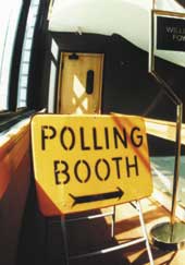 Photo shows a sign outside a polling booth directing people to the voting area. 