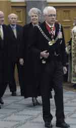 The photo shows the Queen's Herald leading the Governor General, Silvia Cartwright into Parliament. 