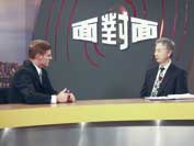 Photo shows Bill English being interviewed on television. 
