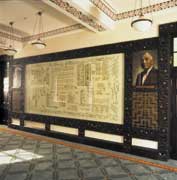 Photo shows the Treaty of Waitangi in a framed case. 